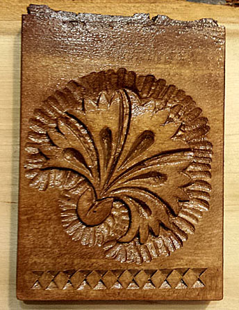 Small hand carved carnation wall decoration with carved laced